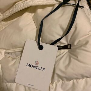 I am selling a Moncler coat. It is a white puffer coat with a belt.